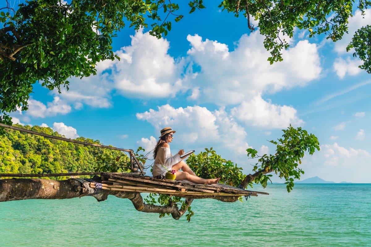 Digital Nomad Working From Her Tablet In A Tropical Location In Thailand, Southeast Asia