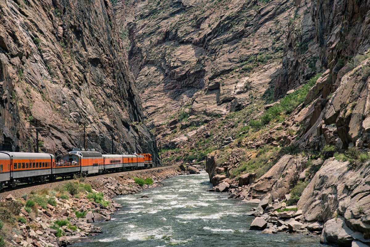 Royal Gorge train passing river in mountainous terrain